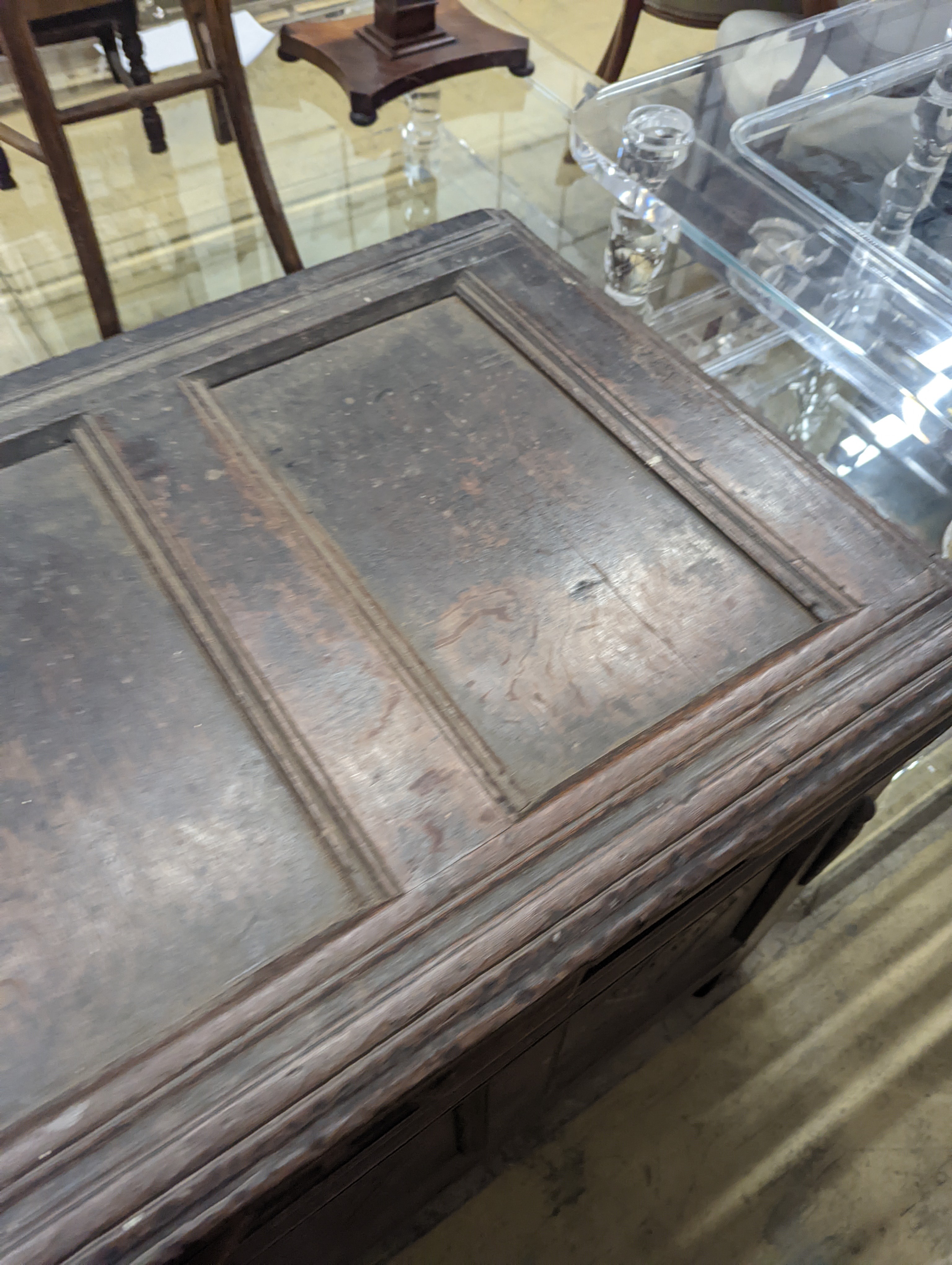 An early 18th century oak coffer, with four panel top and later carved and applied decoration, length 151cm, depth 63cm, height 76cm